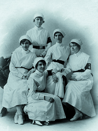 B+W photo of student nurses posting in their uniforms.