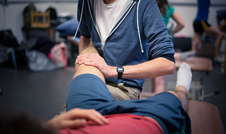  physiotherapy student treating a patient