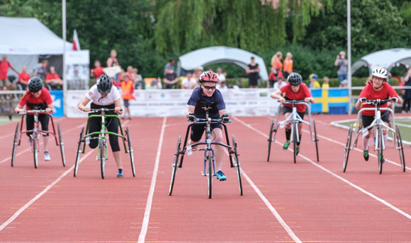 Athletes in wheelchairs racing on the track 