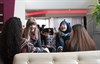 A group of students sit talking and laughing on sofas,  University, Edinburgh